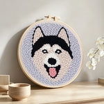 Happy husky punch needle artwork displayed on a table