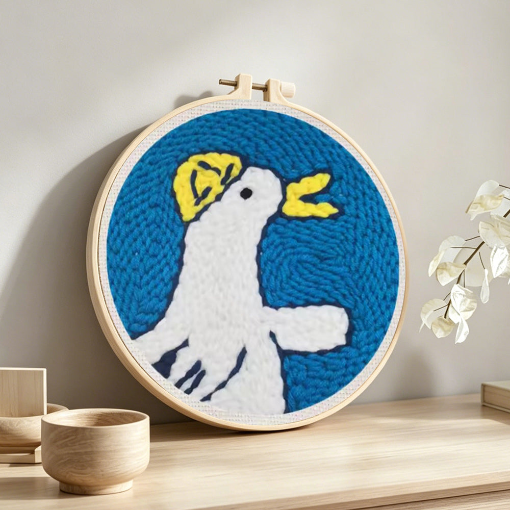 Happy little duck punch needle artwork displayed on a table