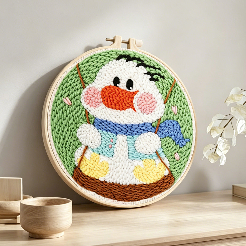 Happy swing duck punch needle artwork displayed on a table