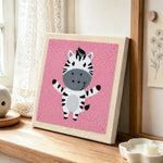 Happy zebra with open arms punch needle artwork displayed on a table