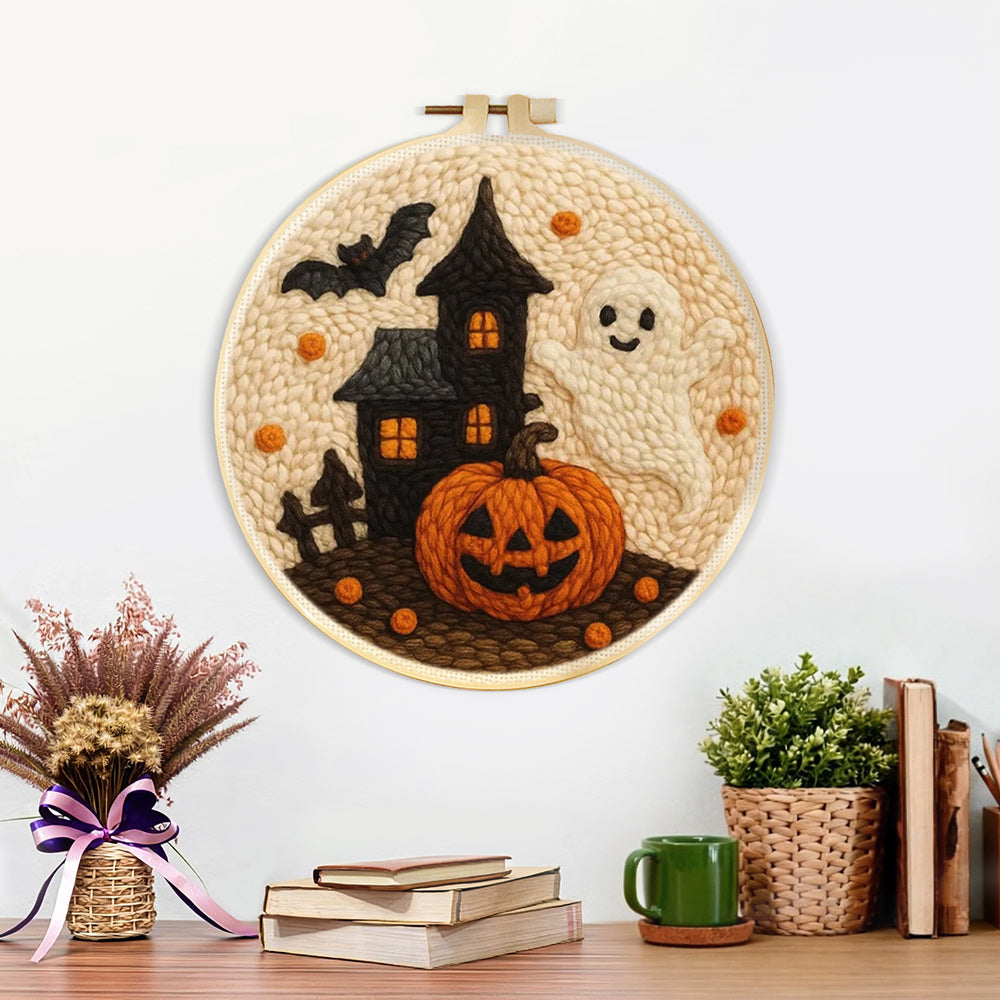 Finished haunted house, ghost and pumpkin artwork displayed on a wall