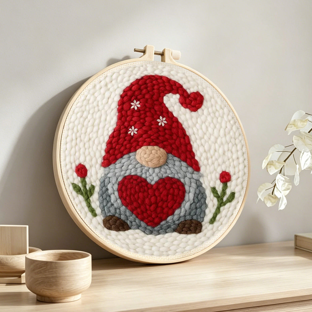 Heart-holding winter gnome punch needle artwork displayed on a table
