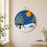 Heart-shaped christmas tree in the snow needle felt wall art displayed in a bright home interior