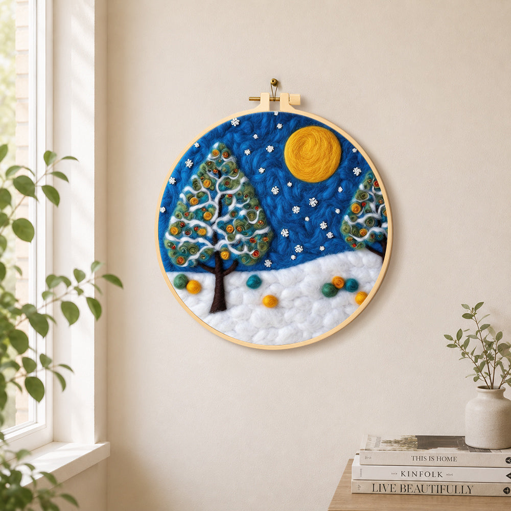 Heart-shaped christmas tree in the snow needle felt wall art displayed in a bright home interior