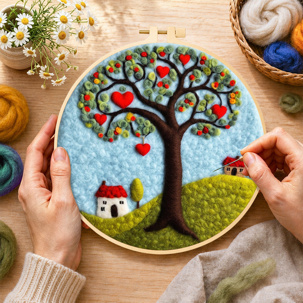 Creating the heart tree and little houses wool painting by hand with a felting needle
