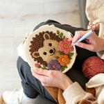 Creating handmade hedgehog with flowers punch needle artwork