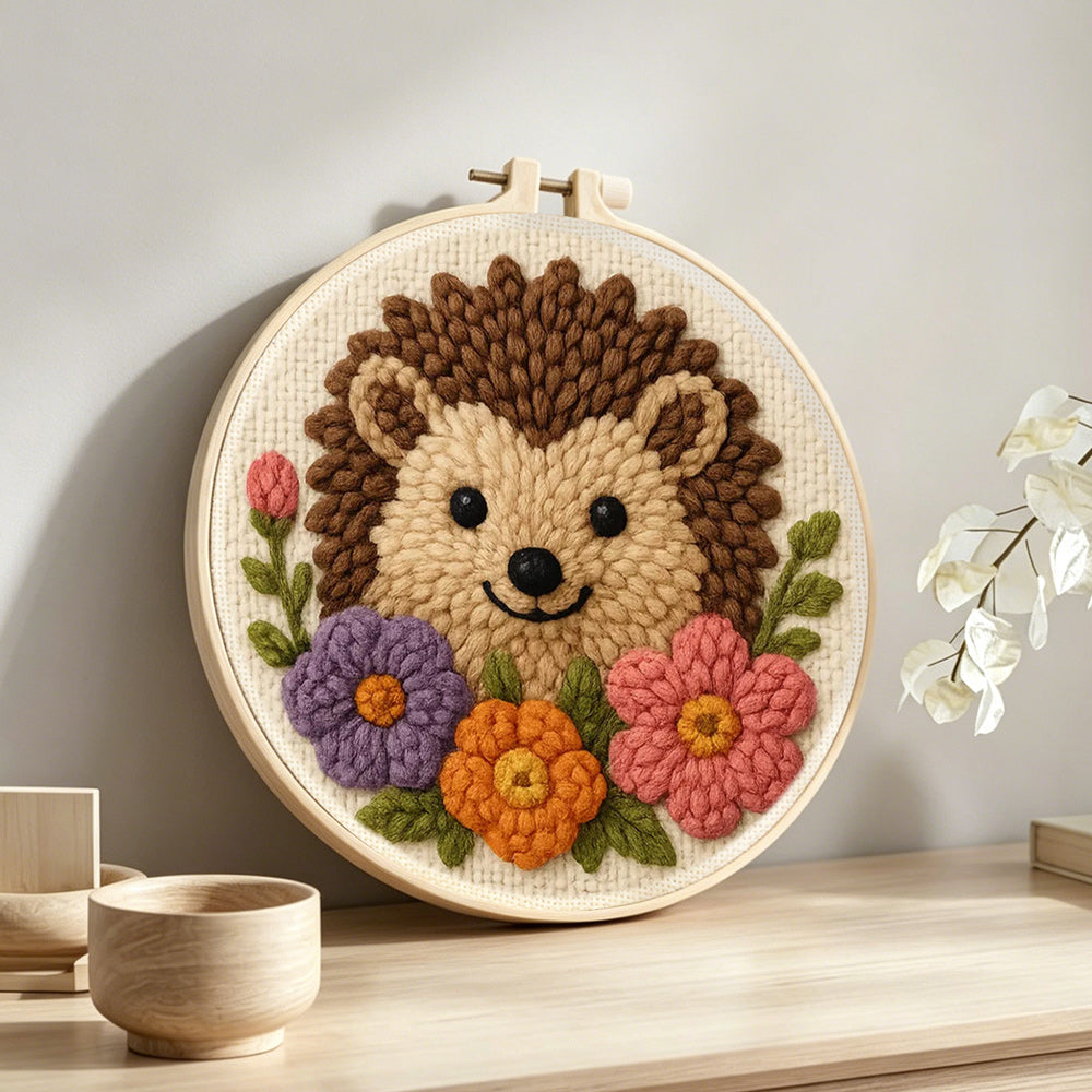Hedgehog with flowers punch needle artwork displayed on a table