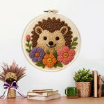 Finished hedgehog with flowers artwork displayed on a wall