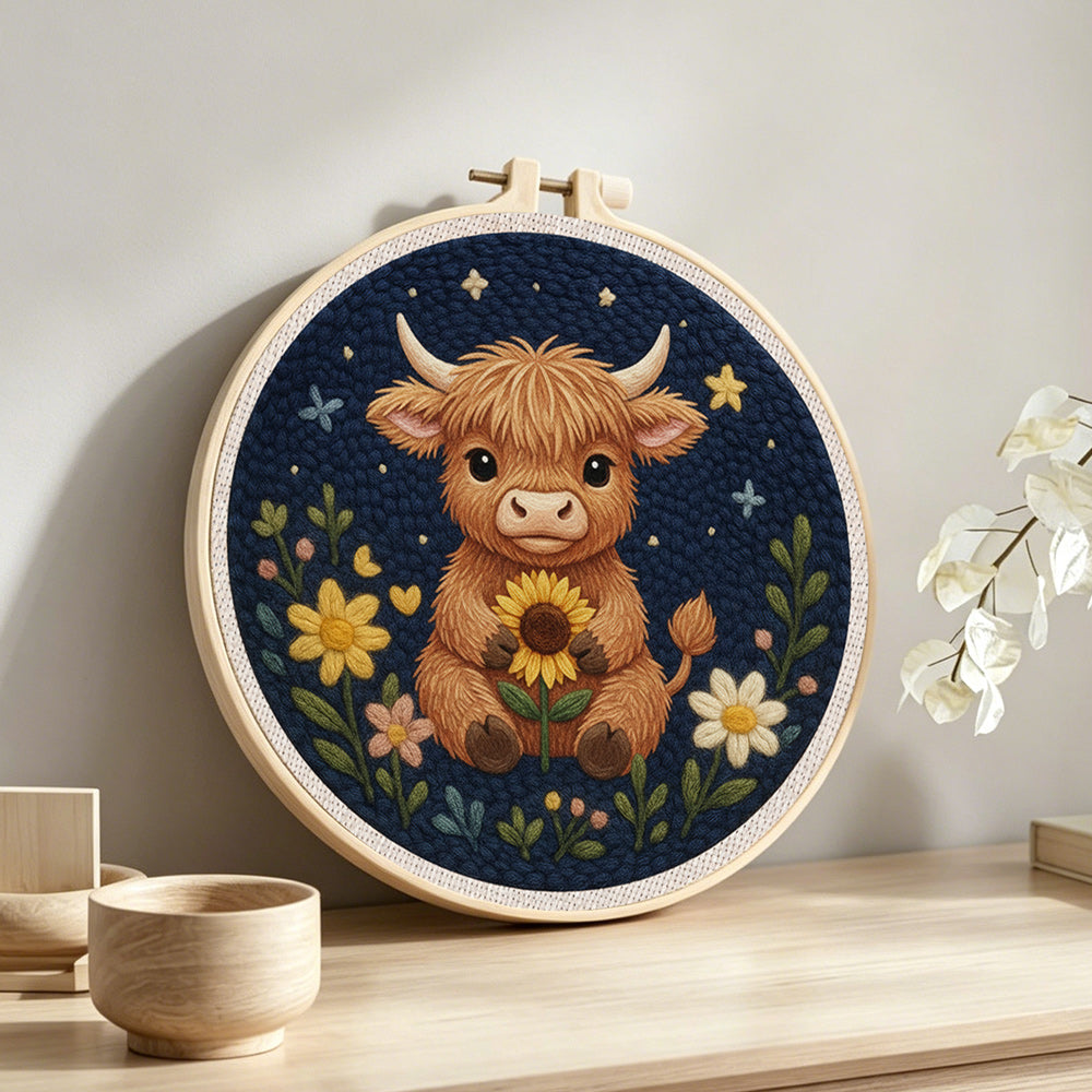 Highland cow and flowers at night punch needle artwork displayed on a table