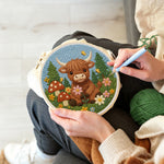 Creating handmade highland cow and mushrooms in spring punch needle artwork