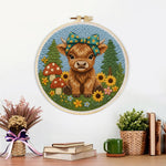 Finished highland cow and mushrooms on the green grass artwork displayed on a wall