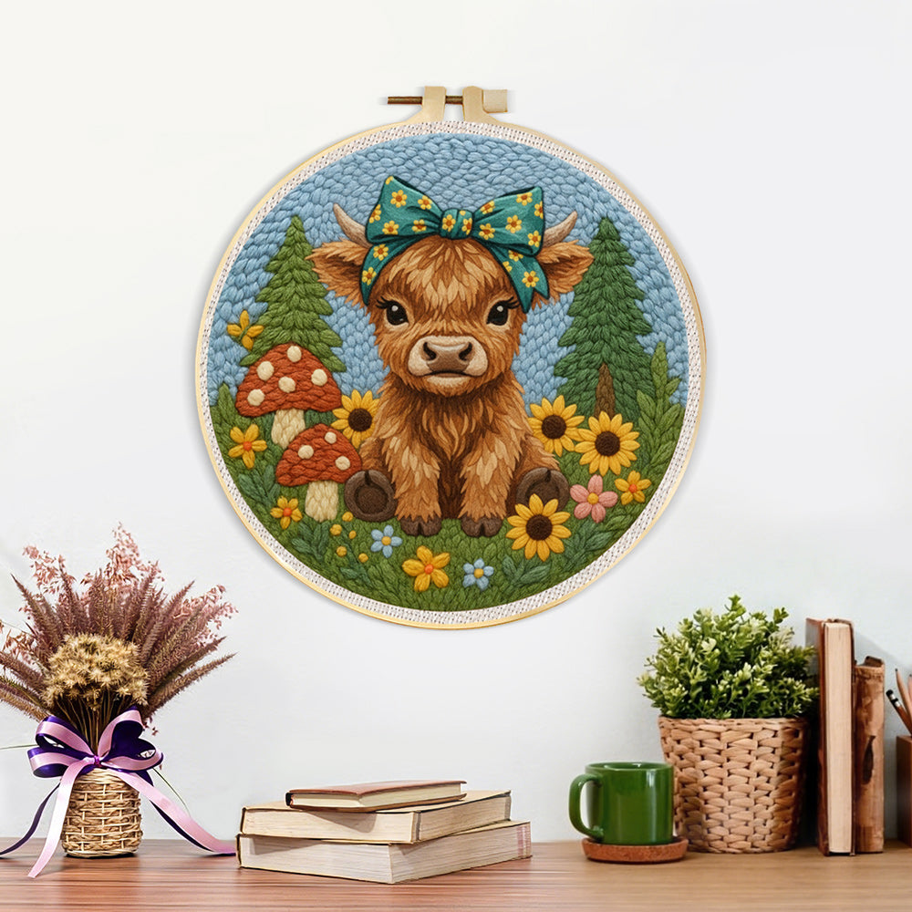 Finished highland cow and mushrooms on the green grass artwork displayed on a wall