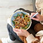 Creating handmade highland cow and sunflowers on the green grass punch needle artwork