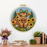 Finished highland cow and sunflowers on the green grass artwork displayed on a wall