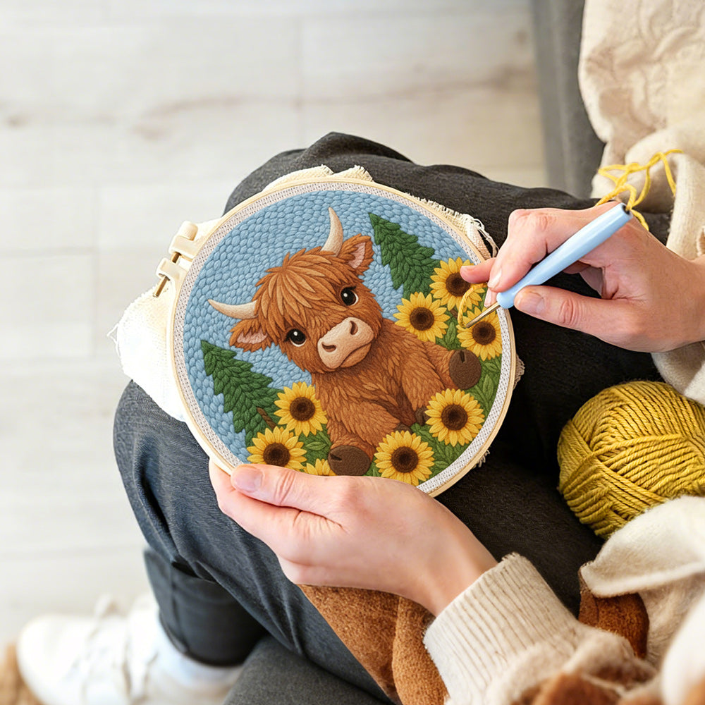 Creating handmade highland cow surrounded by sunflowers punch needle artwork
