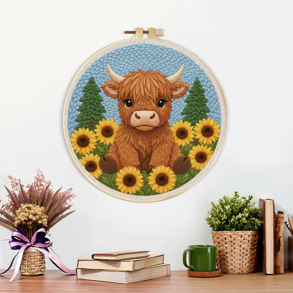 Finished highland cow surrounded by sunflowers artwork displayed on a wall