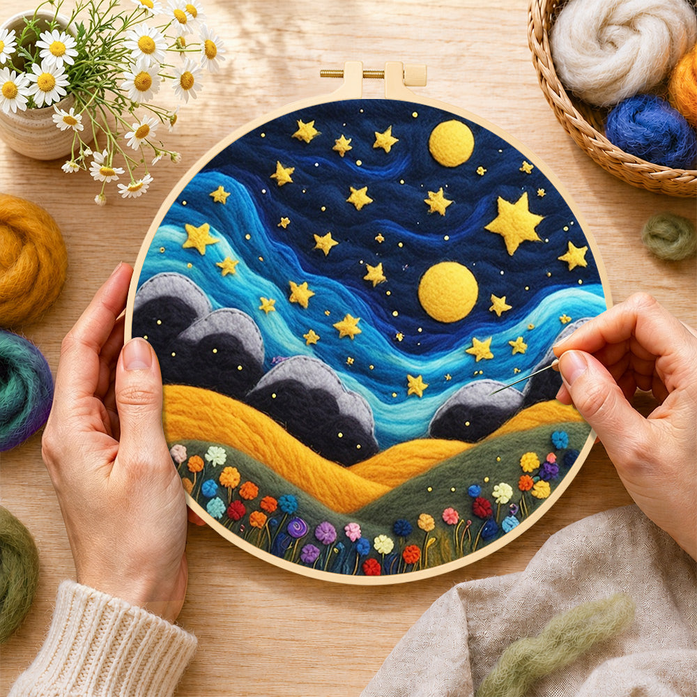 Creating the hills under the whimsical night sky wool painting by hand with a felting needle