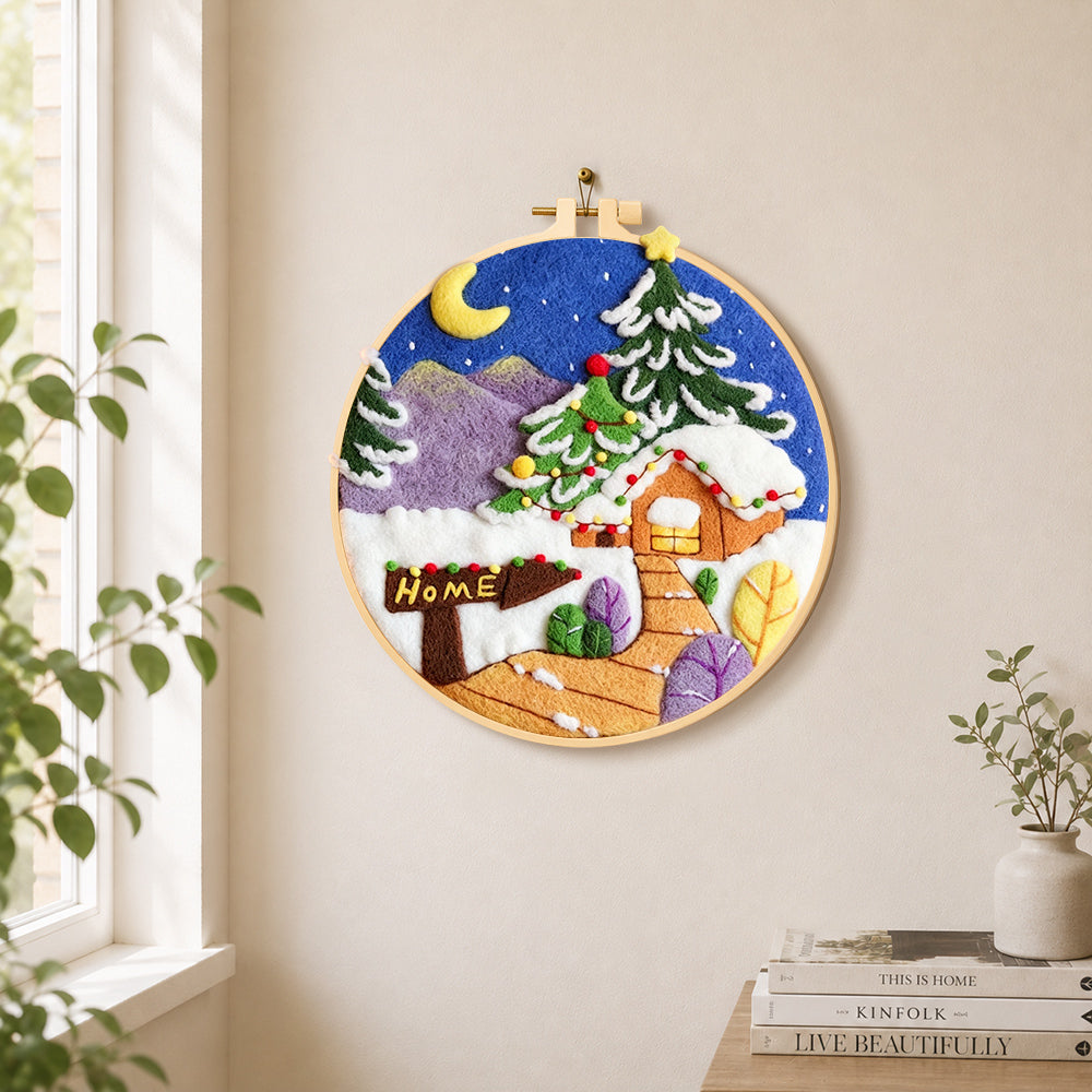 "Home" sign and christmas tree cabin needle felt wall art displayed in a bright home interior