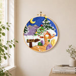 "Home" sign and christmas tree cabin needle felt wall art displayed in a bright home interior