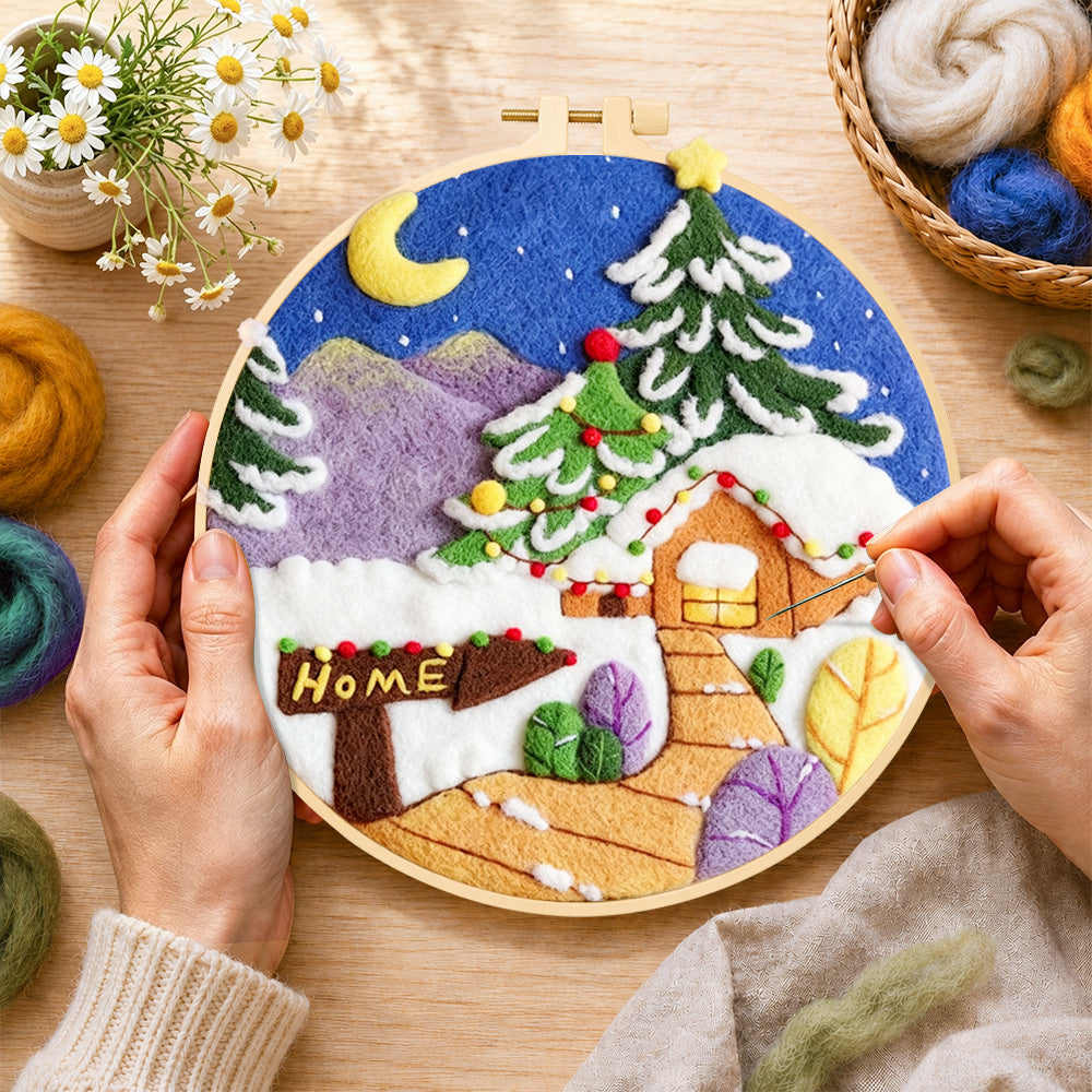 Creating the "home" sign and christmas tree cabin wool painting by hand with a felting needle