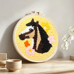 Horse and colourful flowers punch needle artwork displayed on a table