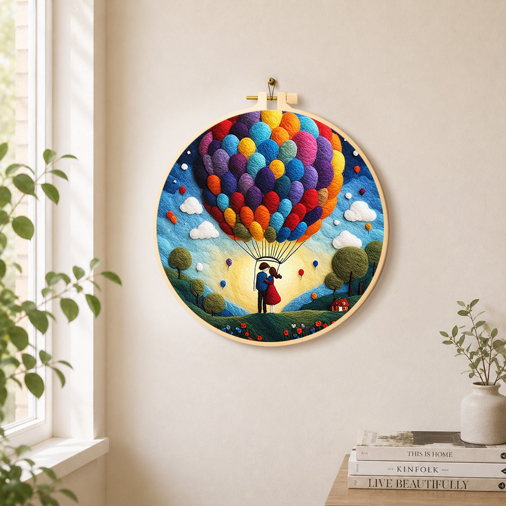 Hot air balloon and romantic couple needle felt wall art displayed in a bright home interior
