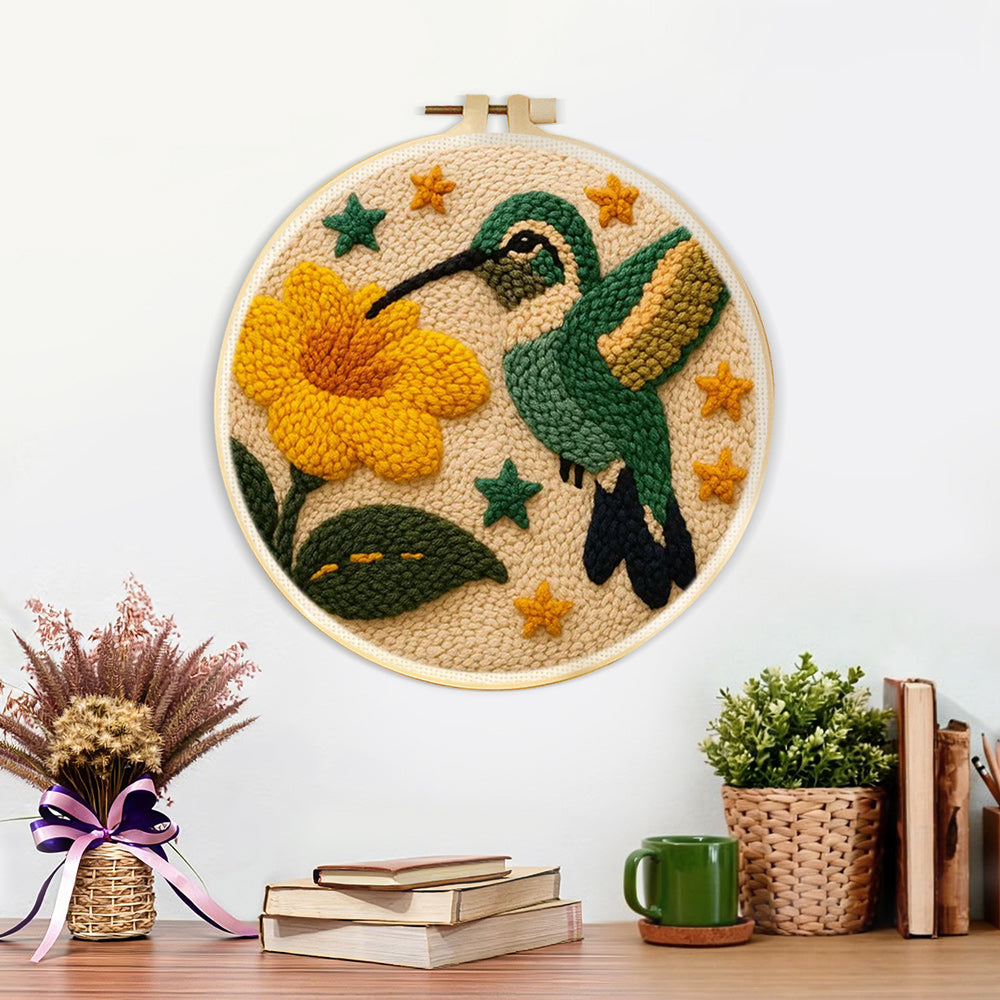 Finished hummingbird and flower artwork displayed on a wall