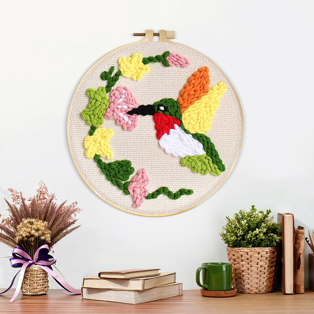 Finished hummingbird and flowers artwork displayed on a wall