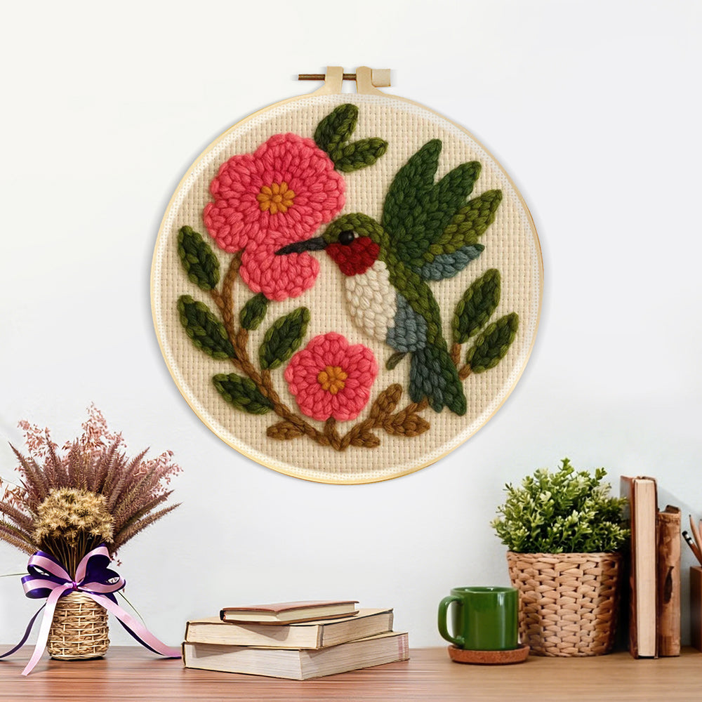 Finished hummingbird and pink flowers artwork displayed on a wall