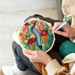 Creating handmade hummingbird in the flower bushes punch needle artwork