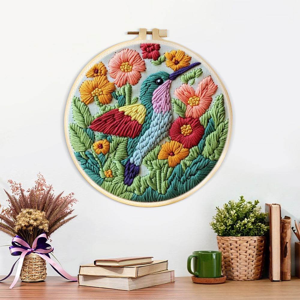 Finished hummingbird in the flower bushes artwork displayed on a wall