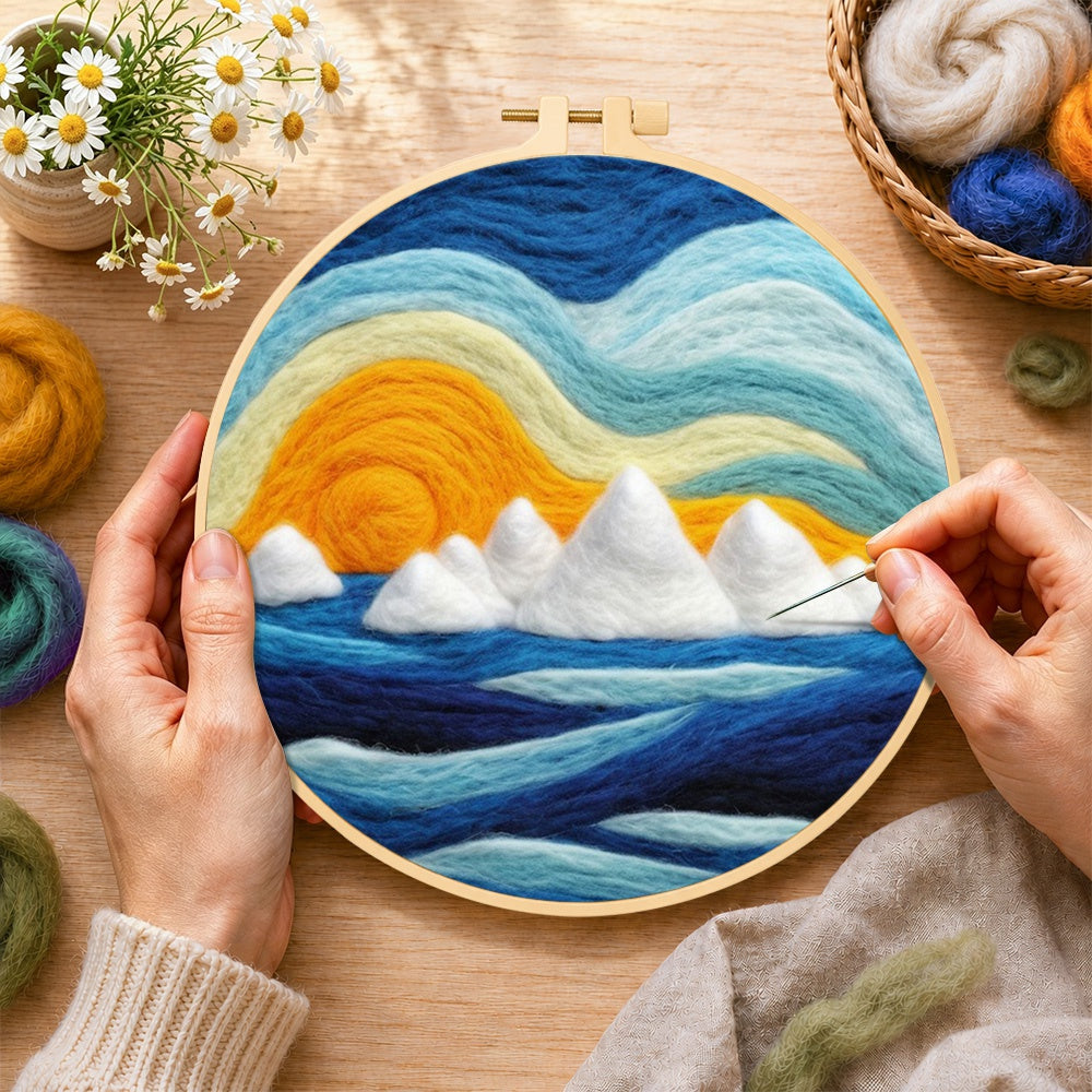 Creating the icebergs at sunset wool painting by hand with a felting needle