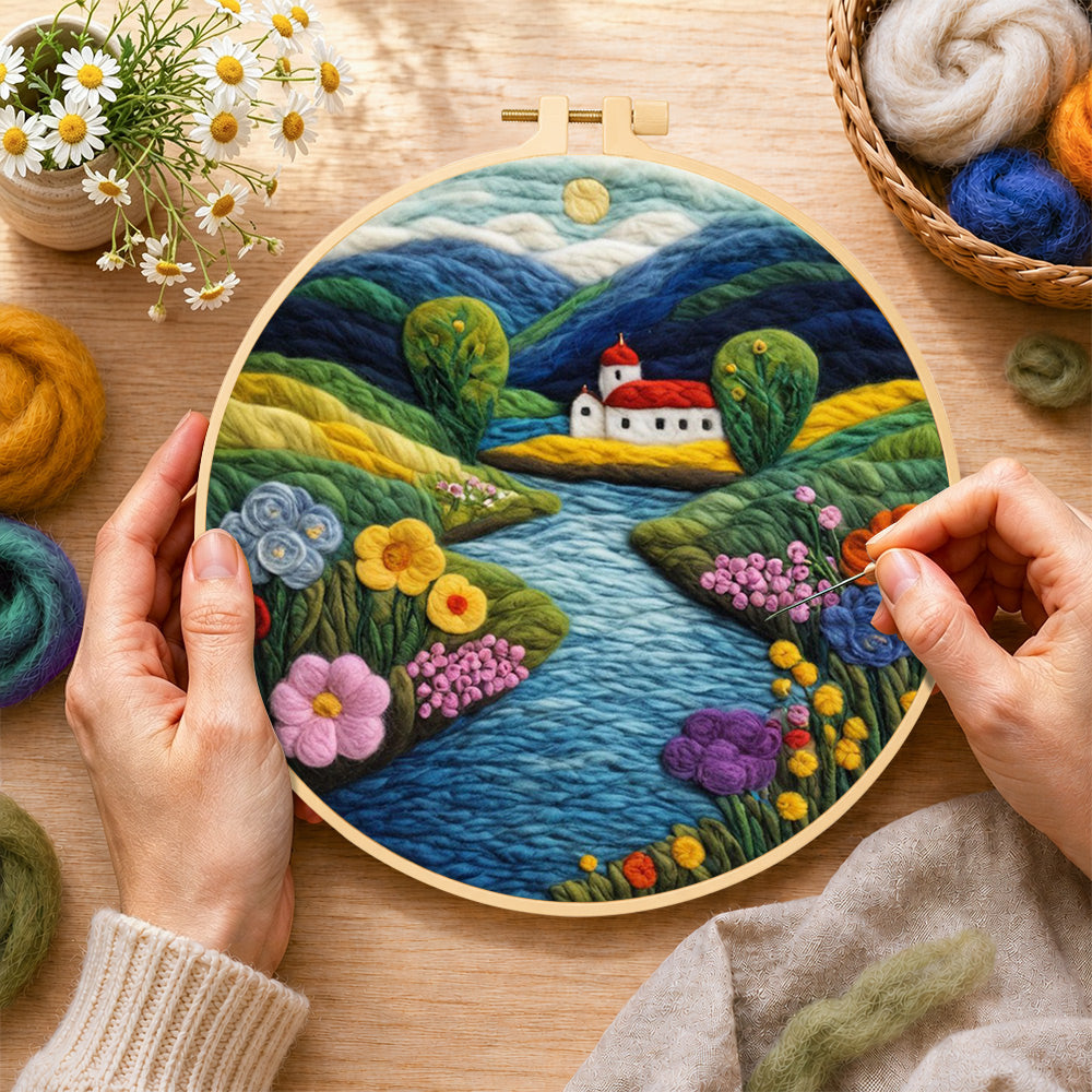 Creating the idyllic mountain village and river wool painting by hand with a felting needle
