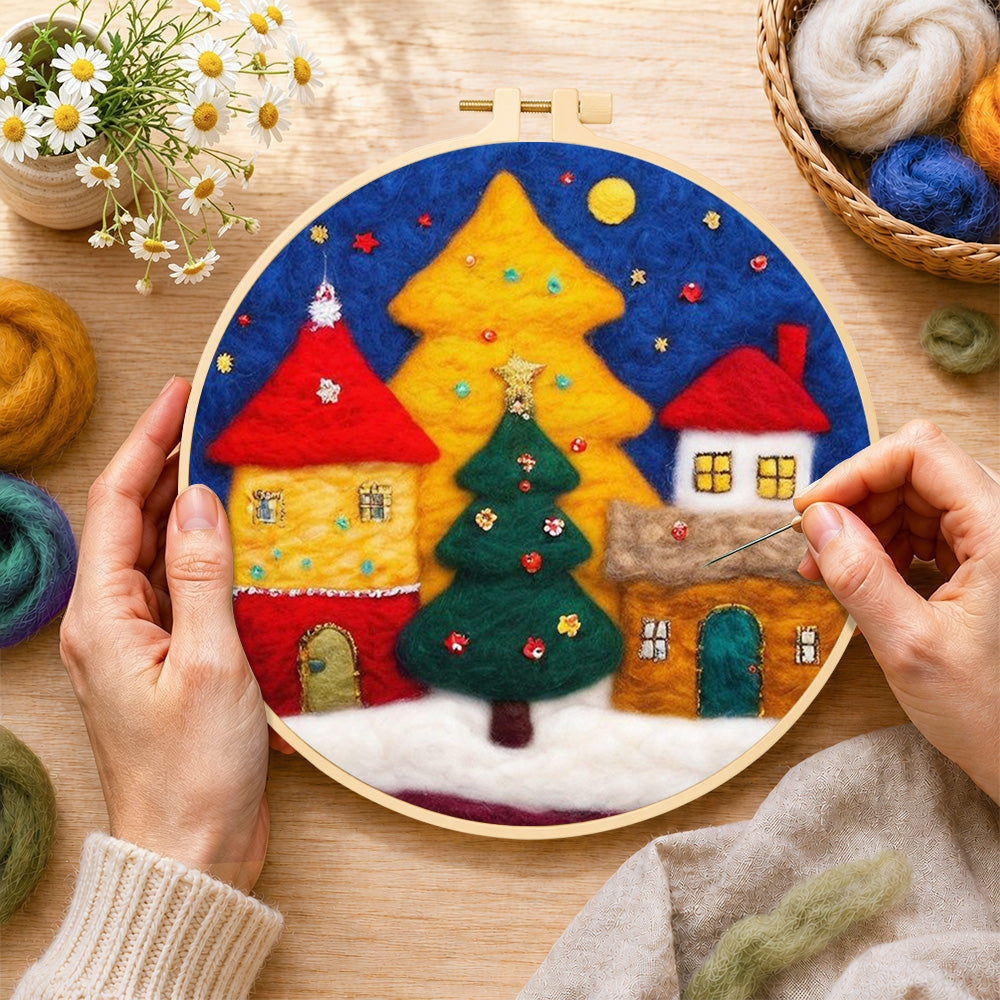 Creating the illuminated christmas village wool painting by hand with a felting needle