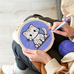 Creating handmade innocent little kitten punch needle artwork