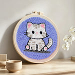 Innocent little kitten punch needle artwork displayed on a table