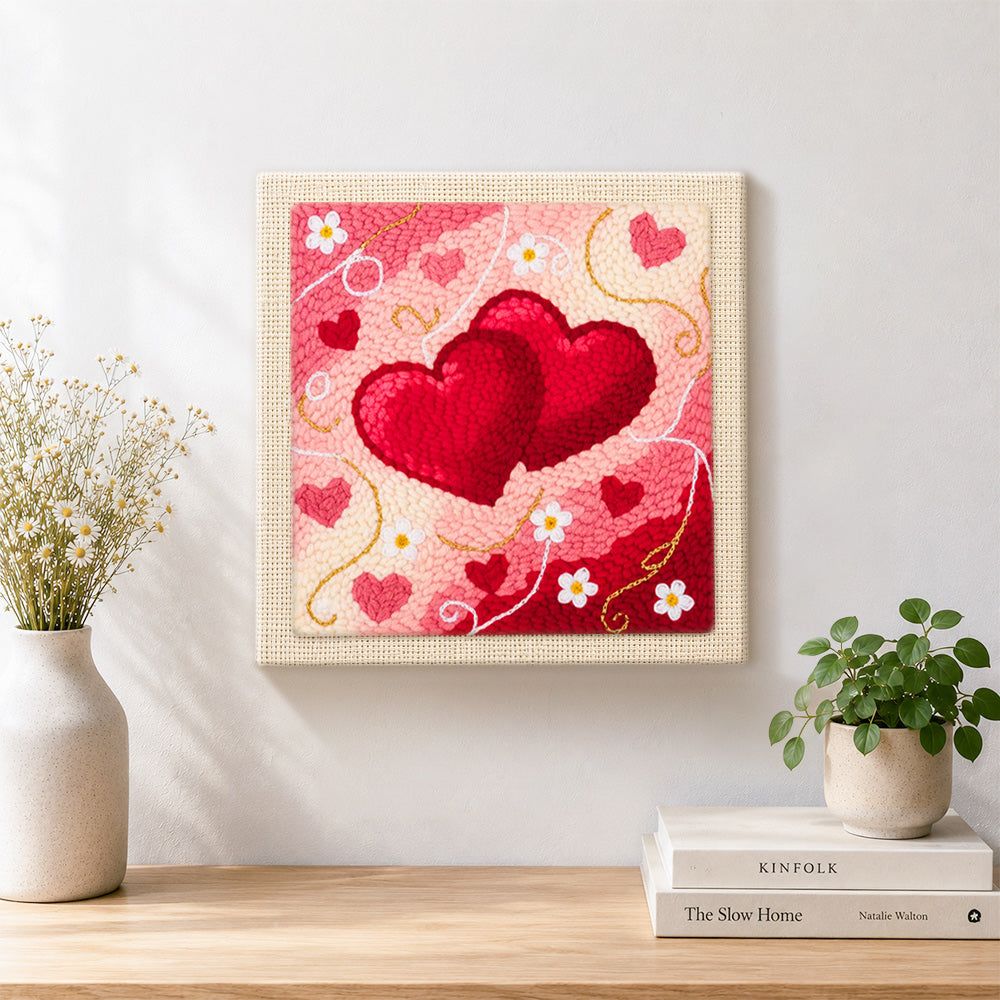 Finished intertwined hearts artwork displayed on a wall