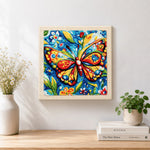 Finished intricate floral butterfly artwork displayed on a wall