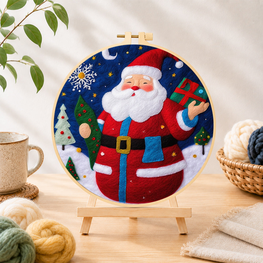 Finished jolly santa holding gift and tree needle felting displayed on a wooden easel