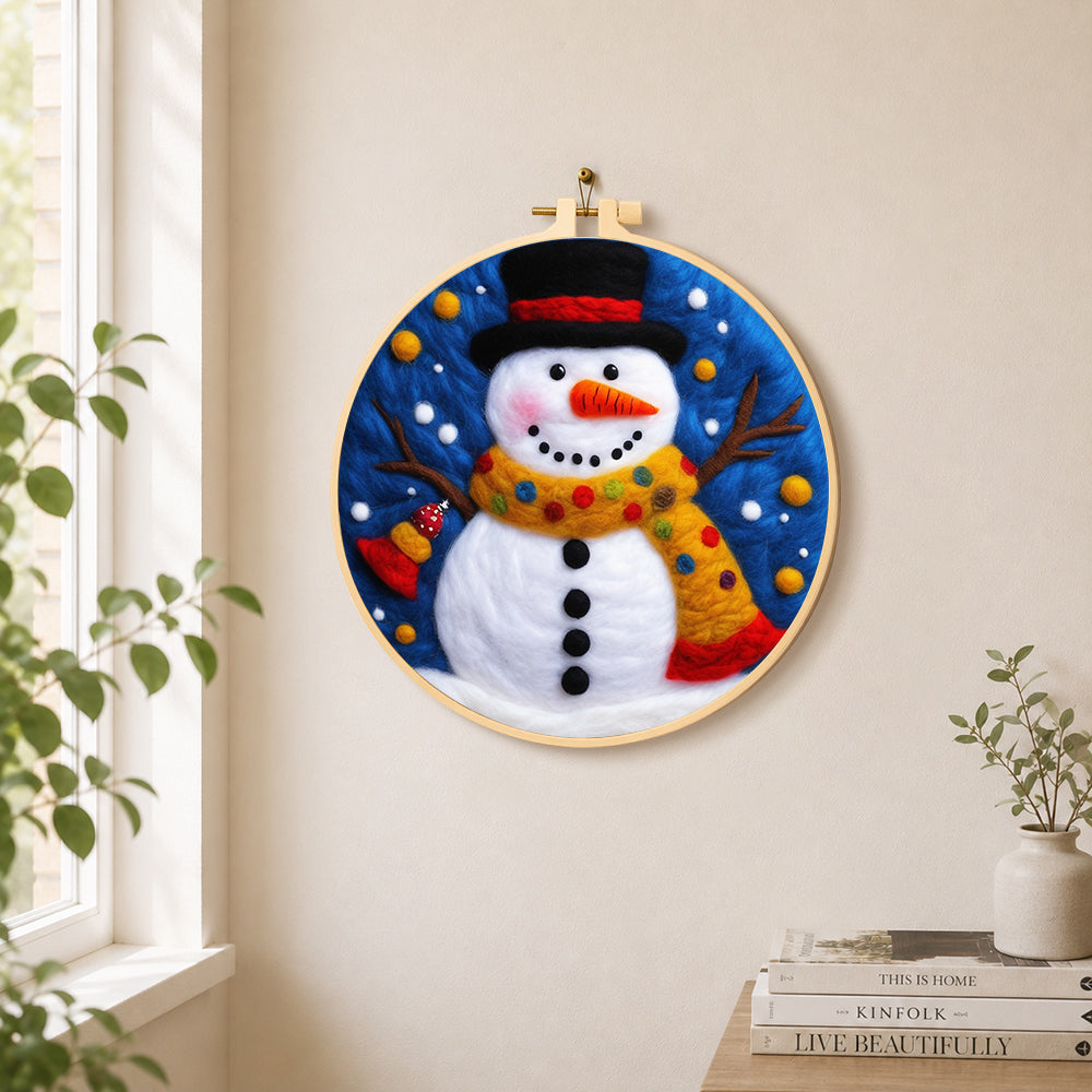 Jolly snowman with top hat and scarf needle felt wall art displayed in a bright home interior