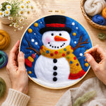 Creating the jolly snowman with top hat and scarf wool painting by hand with a felting needle
