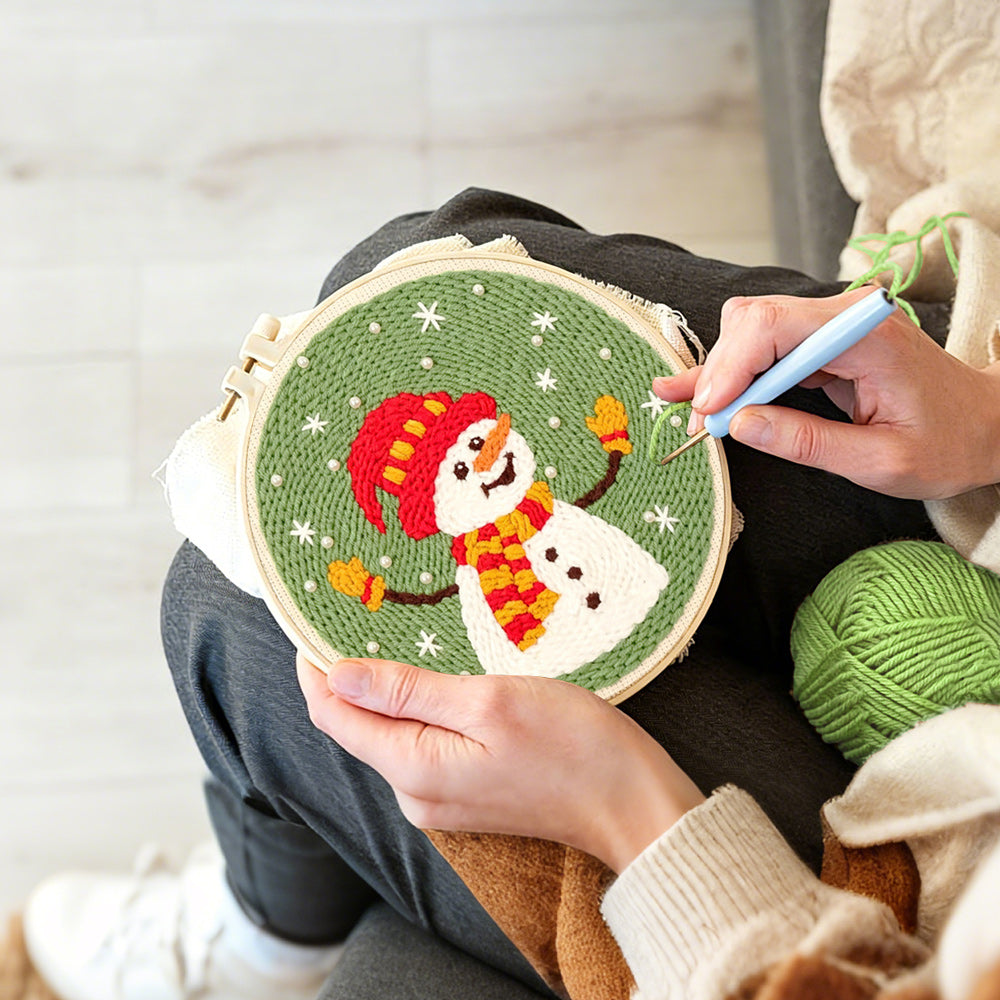 Creating handmade joyful snowman in winter hat punch needle artwork