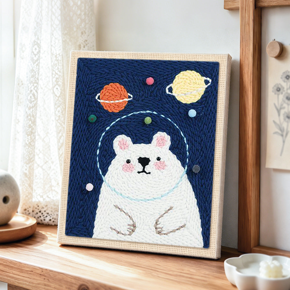 Kawaii astronaut bear punch needle artwork displayed on a table