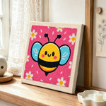 Kawaii blue-winged bee punch needle artwork displayed on a table
