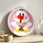 Kawaii duck with milk tea punch needle artwork displayed on a table