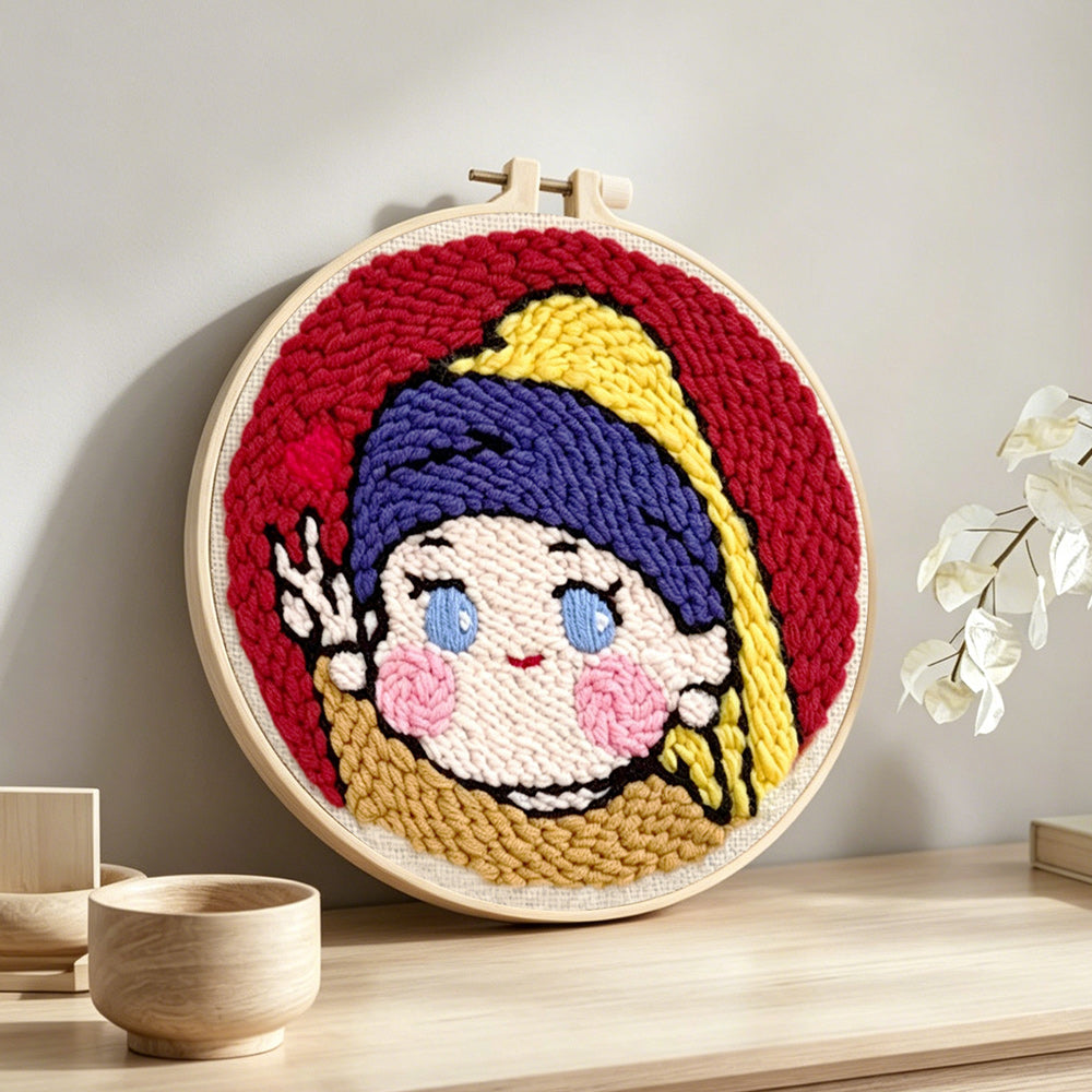 Kawaii "girl with a pearl earring" parody punch needle artwork displayed on a table