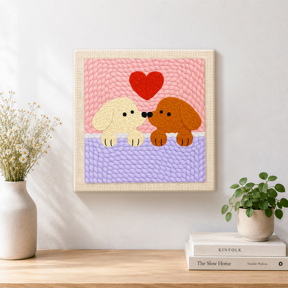 Finished kissing puppies with red heart artwork displayed on a wall