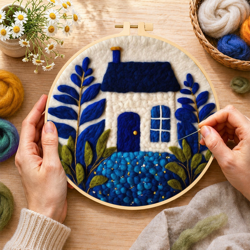 Creating the klein blue and white cottage wool painting by hand with a felting needle