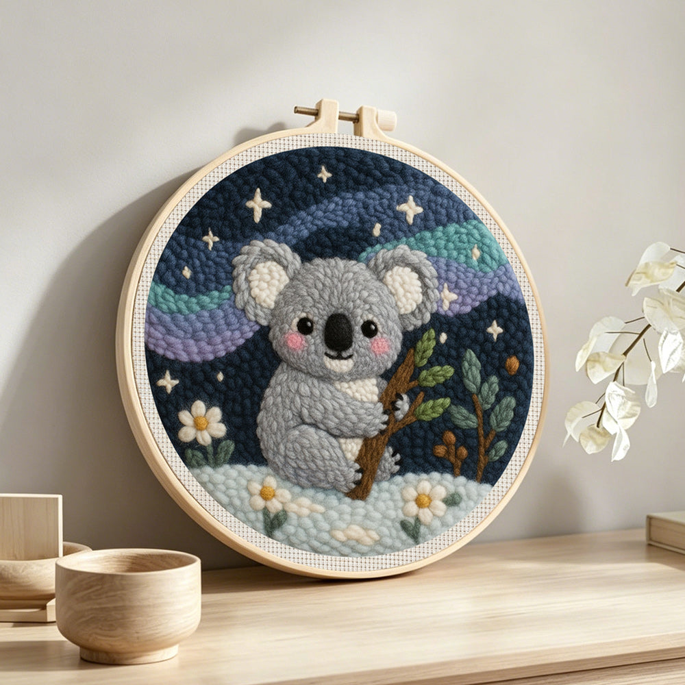 Koala and mountains under the stars punch needle artwork displayed on a table