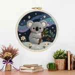 Finished koala and mountains under the stars artwork displayed on a wall